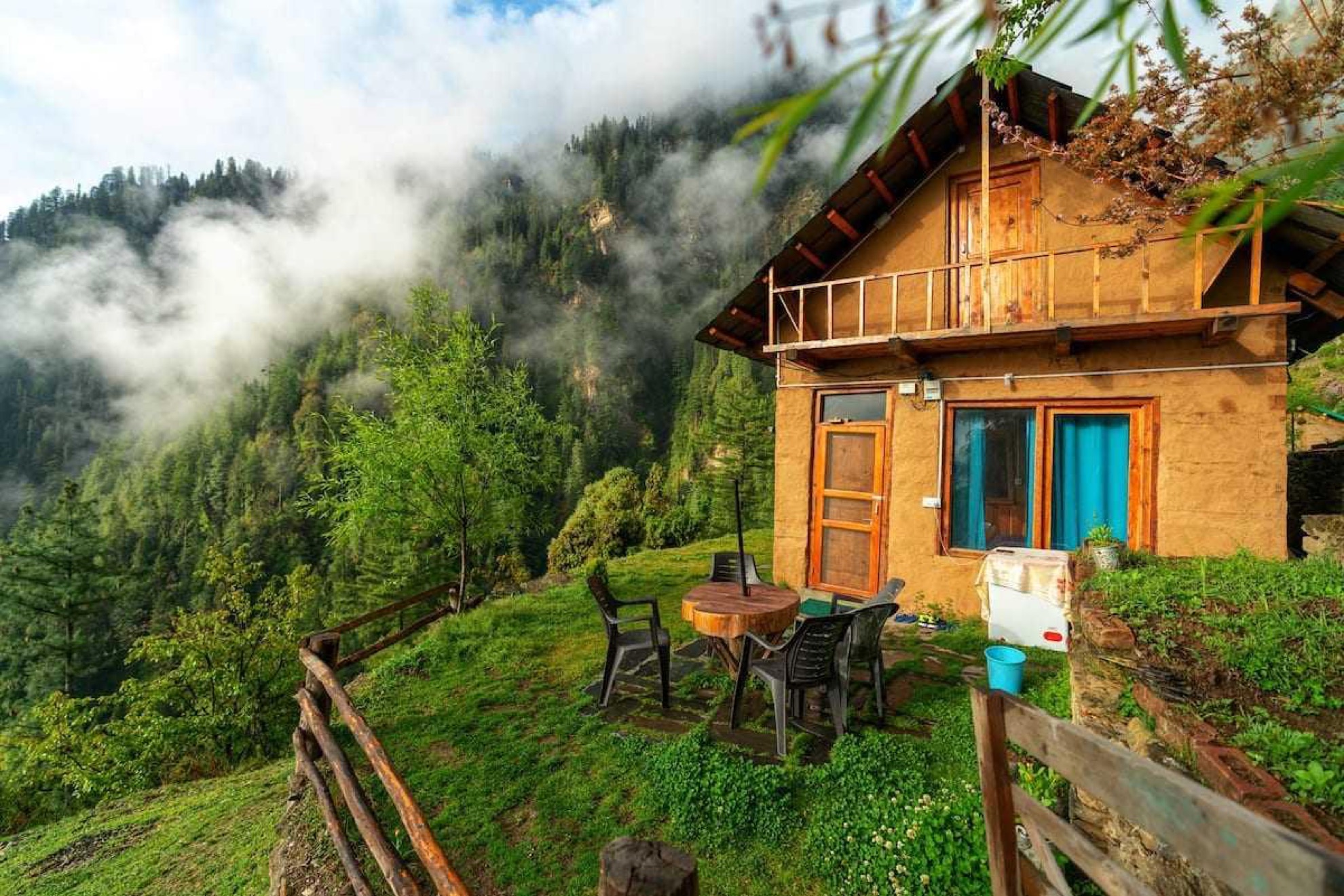 A wooden house among trees at sunrise